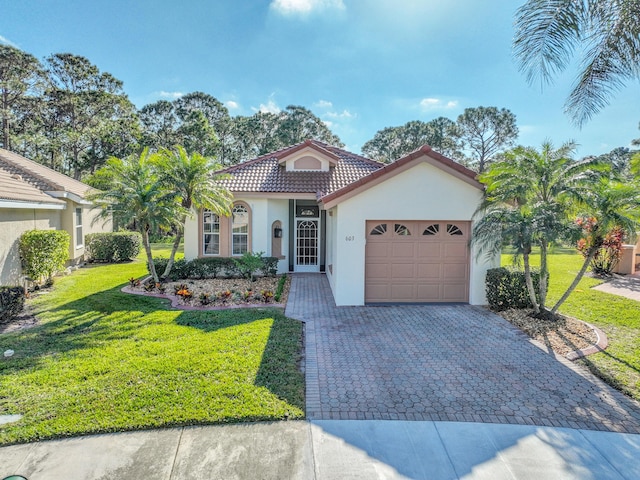 mediterranean / spanish-style home with a garage and a front lawn