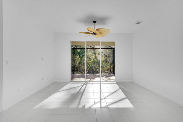 tiled spare room featuring ceiling fan