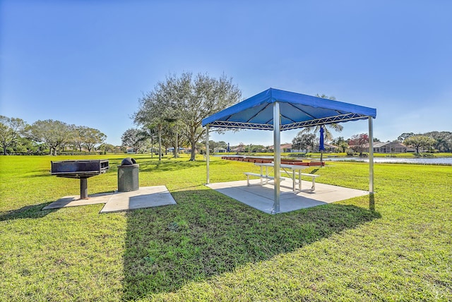 view of home's community with a yard, a patio area, a water view, and a gazebo