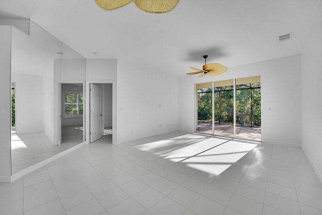 spare room featuring light tile patterned flooring and ceiling fan