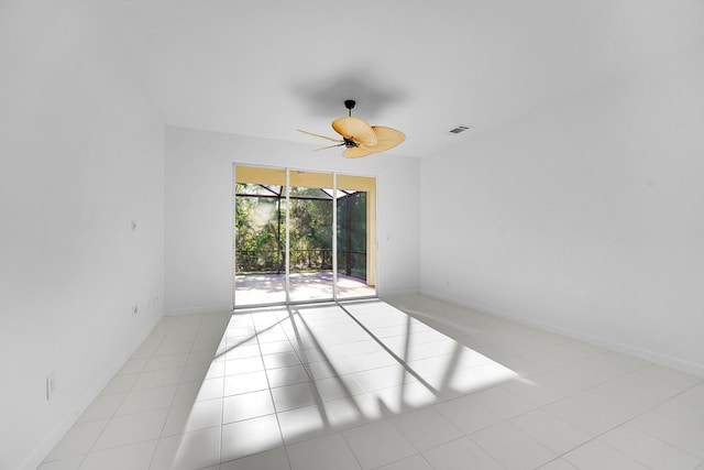 tiled spare room featuring ceiling fan