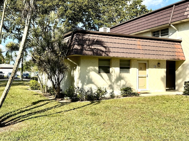 view of property exterior with a yard