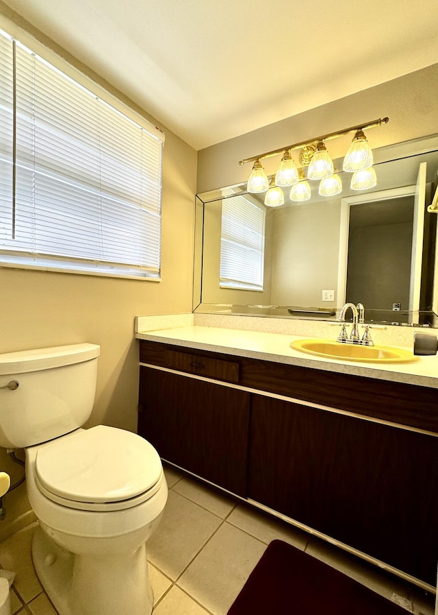 bathroom featuring tile patterned floors, toilet, and vanity