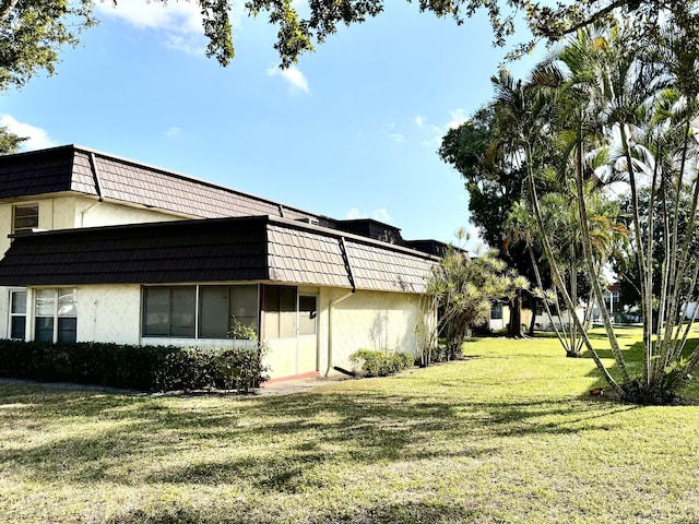 view of side of home featuring a yard