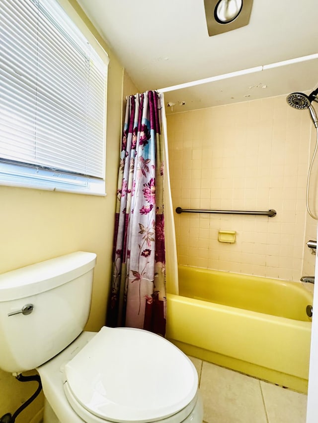 bathroom featuring toilet, shower / bathtub combination with curtain, and tile patterned flooring