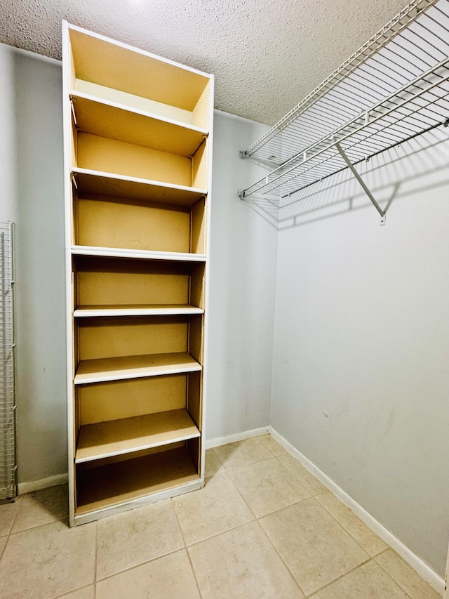 spacious closet featuring tile patterned floors