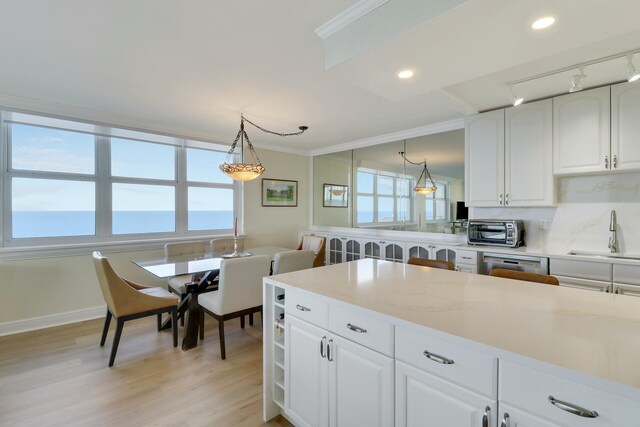 kitchen featuring white cabinetry, sink, pendant lighting, and appliances with stainless steel finishes