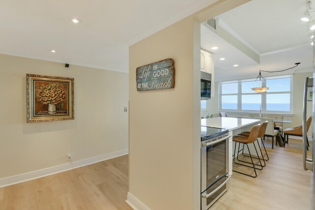 hall featuring crown molding and light wood-type flooring