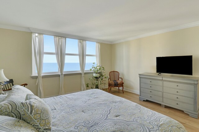 bedroom featuring crown molding and light wood-type flooring