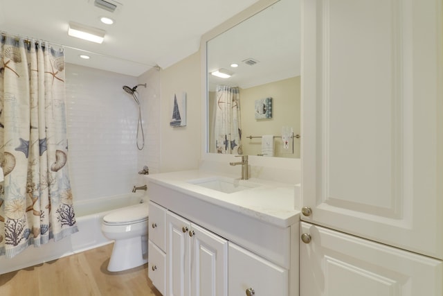 full bathroom featuring vanity, hardwood / wood-style flooring, toilet, and shower / bath combo with shower curtain