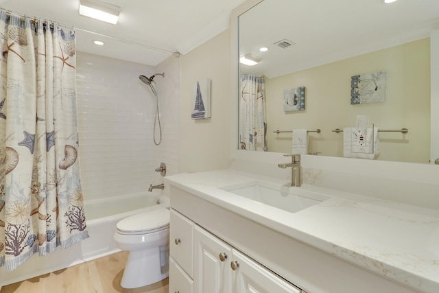 full bathroom featuring shower / tub combo, vanity, wood-type flooring, and toilet