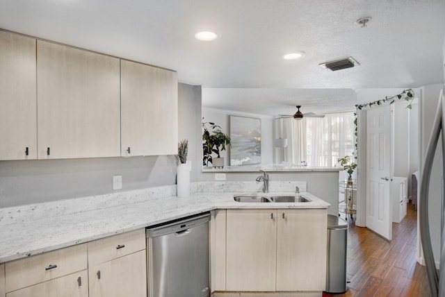 kitchen featuring light brown cabinetry, sink, dark hardwood / wood-style flooring, stainless steel appliances, and light stone countertops