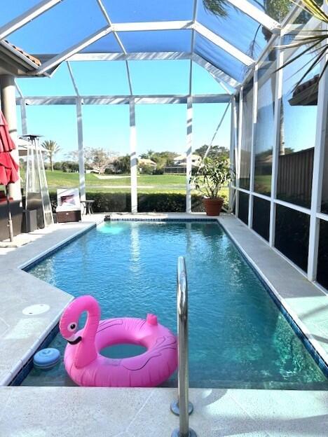 view of pool with a lanai and a patio area