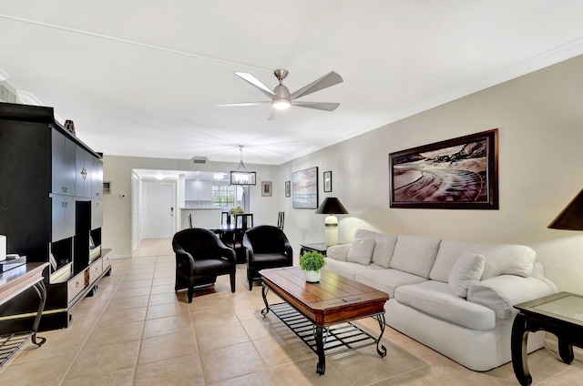 tiled living room with crown molding and ceiling fan