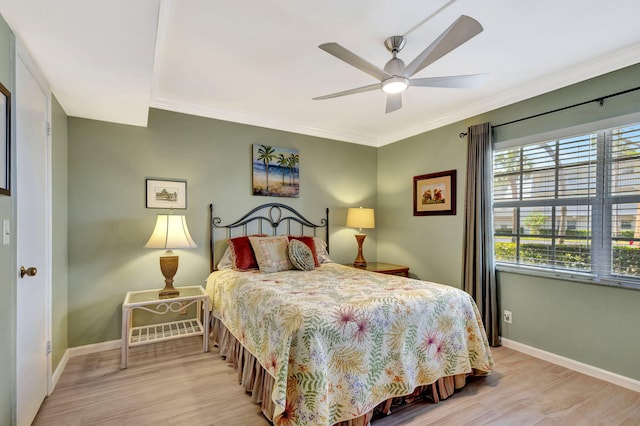 bedroom with ceiling fan, ornamental molding, and light hardwood / wood-style floors