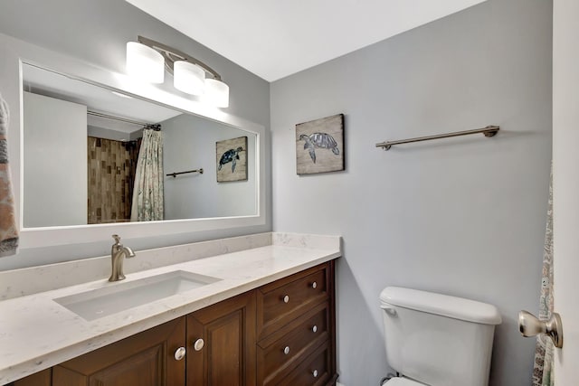 bathroom with vanity, a shower with shower curtain, and toilet