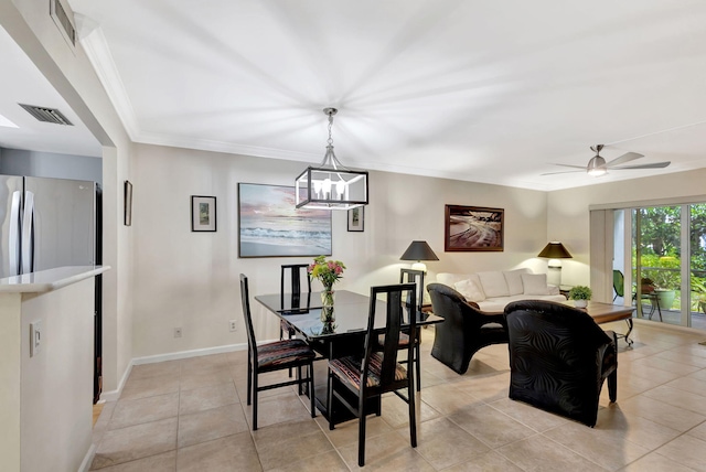 tiled dining space featuring ornamental molding and ceiling fan