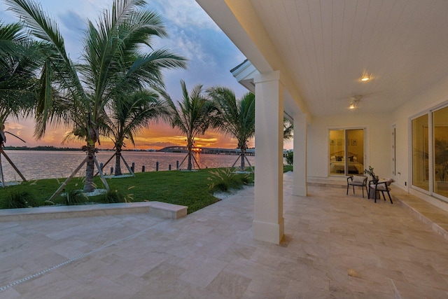 patio terrace at dusk with a water view