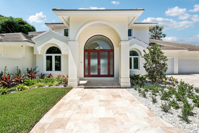 view of exterior entry featuring french doors