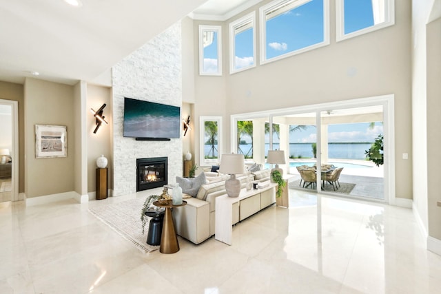 living room featuring a high ceiling and a fireplace