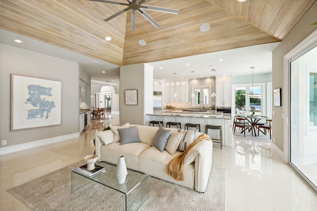 living room with wood ceiling, ceiling fan, and light tile patterned flooring