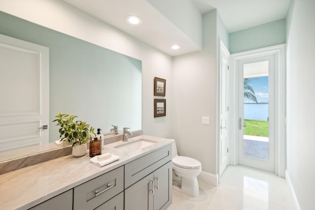 bathroom with vanity, tile patterned floors, and toilet