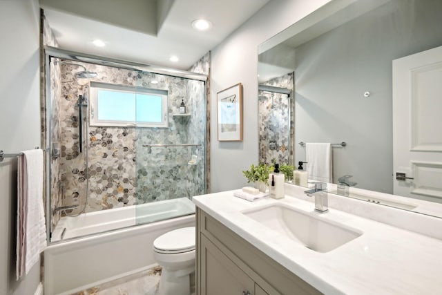 full bathroom featuring enclosed tub / shower combo, vanity, and toilet