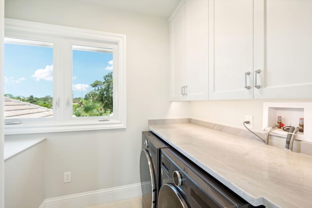 washroom featuring cabinets and washer / clothes dryer