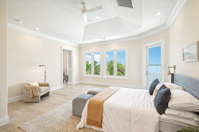 bedroom with access to outside, light hardwood / wood-style flooring, ornamental molding, and a water view