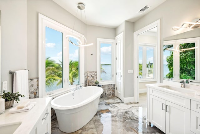 bathroom featuring vanity and a tub