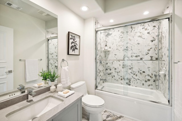 full bathroom featuring vanity, enclosed tub / shower combo, and toilet