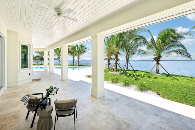 view of patio / terrace featuring ceiling fan and a water view