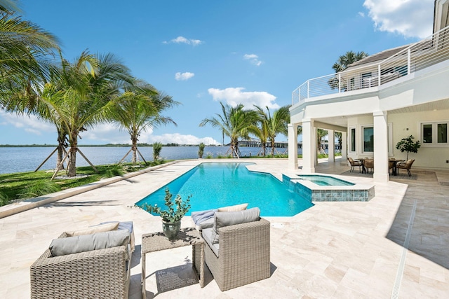 view of swimming pool featuring an in ground hot tub, a patio, outdoor lounge area, and a water view