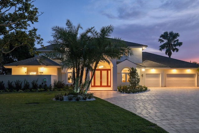 view of front of house featuring a garage and a yard