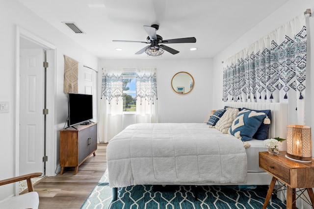 bedroom with wood-type flooring and ceiling fan