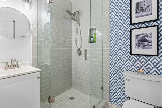 bathroom featuring vanity, toilet, and walk in shower