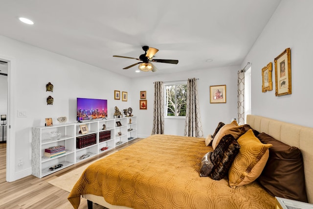 bedroom with ceiling fan and light hardwood / wood-style flooring