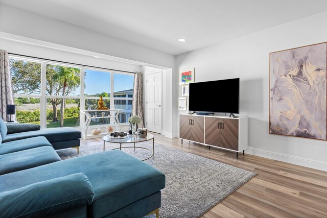 living room with indoor bar and light wood-type flooring