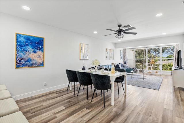 dining space with hardwood / wood-style flooring and ceiling fan