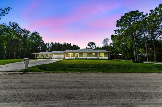 view of front of property featuring a garage and a front yard