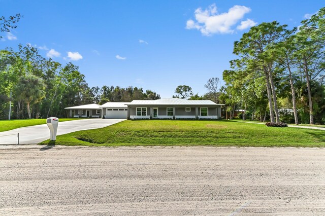 ranch-style home featuring a yard and a garage