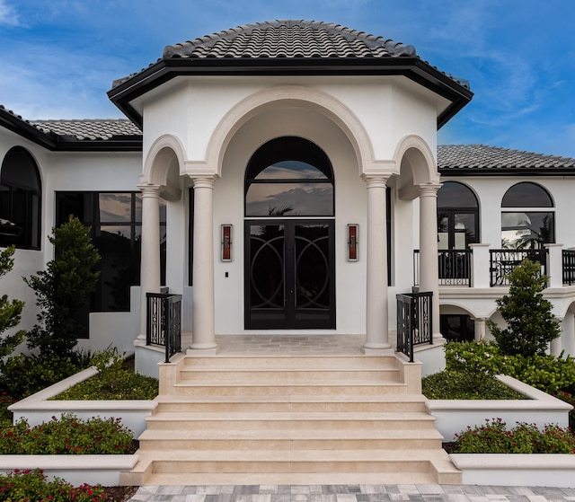 view of exterior entry featuring french doors