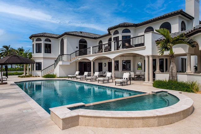 back of house featuring a gazebo, a patio area, and a balcony