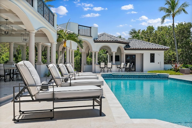 view of pool with a bar, a patio area, and ceiling fan