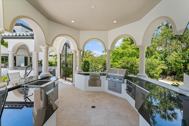 view of patio with area for grilling and a grill