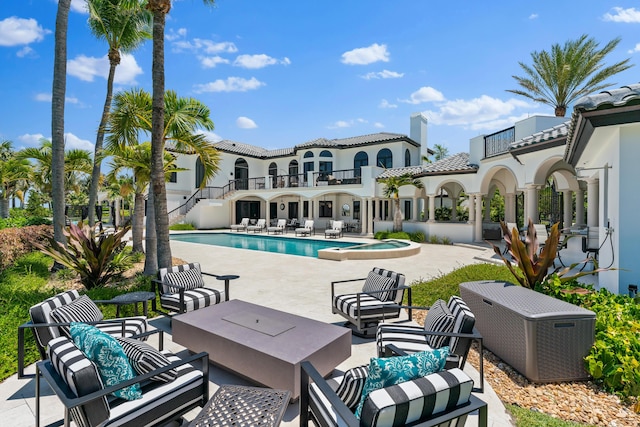 view of pool with an in ground hot tub, an outdoor living space, and a patio