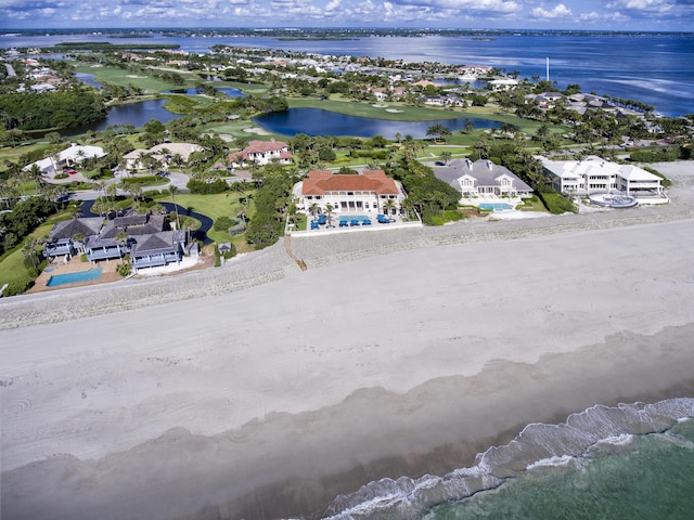 drone / aerial view with a water view and a beach view