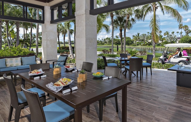 view of patio / terrace with a deck with water view and an outdoor living space