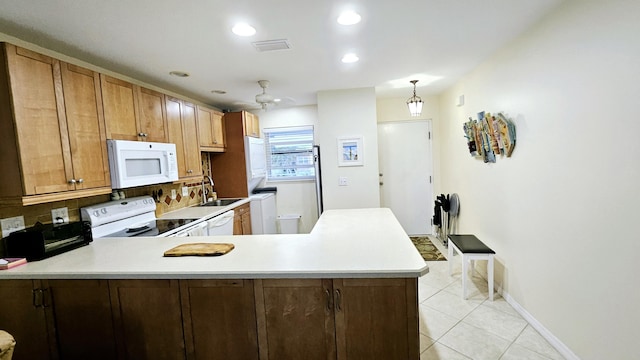 kitchen featuring pendant lighting, light tile patterned floors, ceiling fan, kitchen peninsula, and white appliances