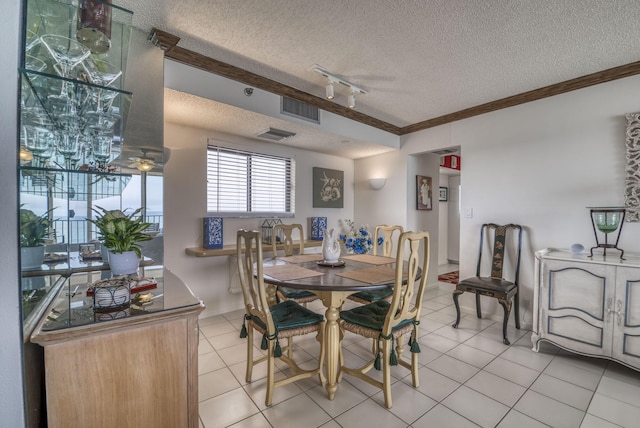 dining space featuring light tile patterned flooring, rail lighting, ornamental molding, and a textured ceiling